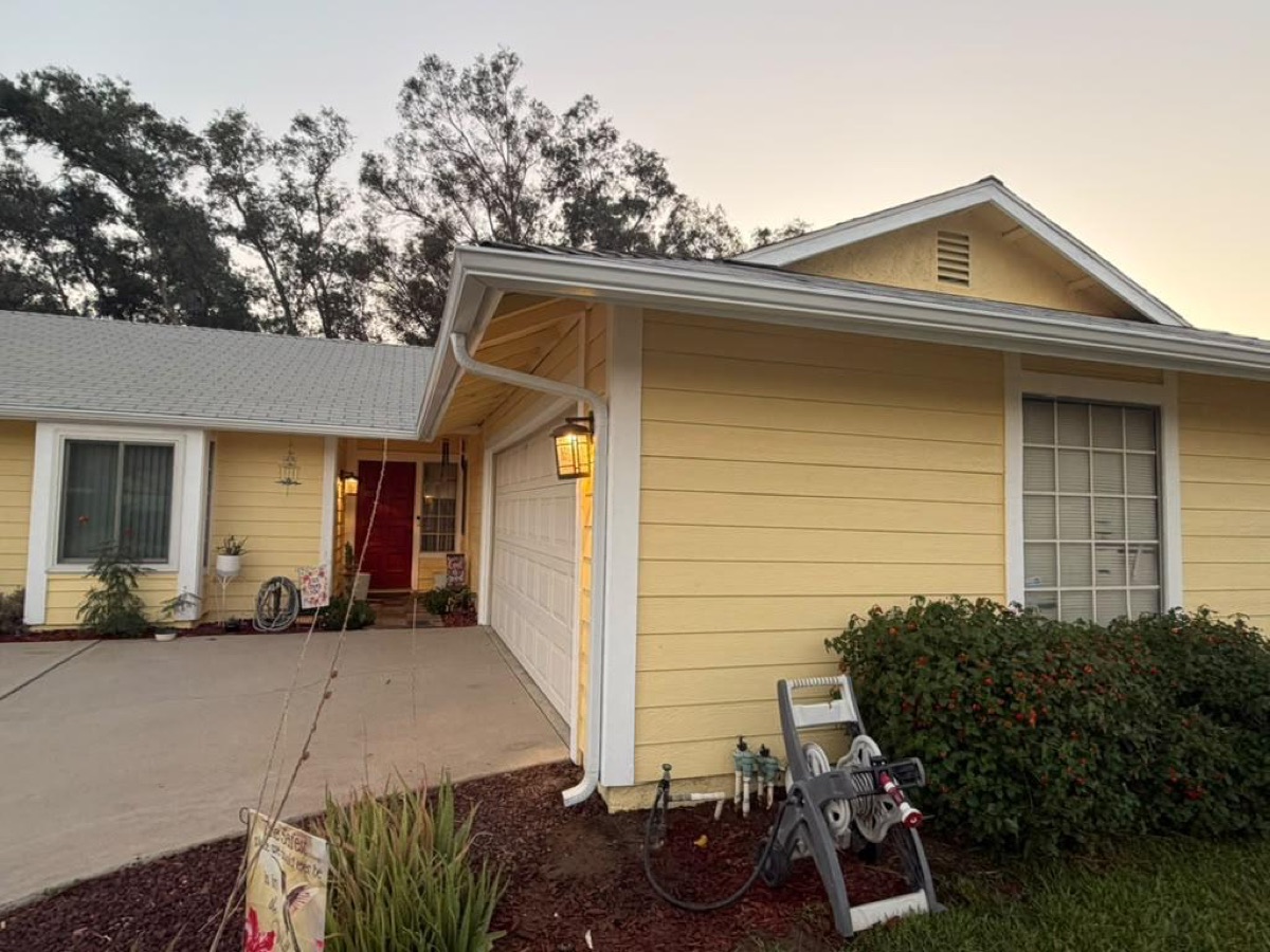 After: Front of home — new seamless gutters & downspout