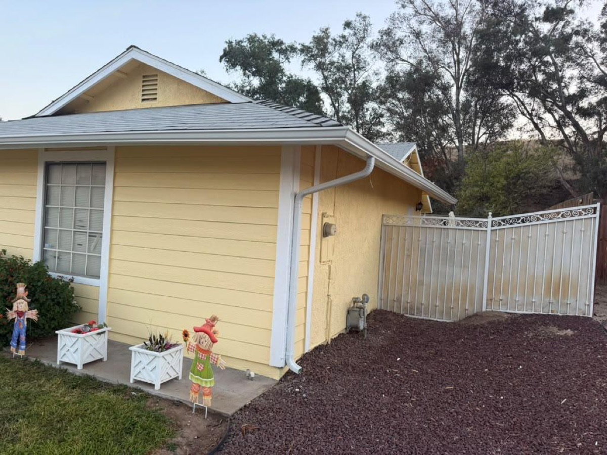 After: Side yard — seamless gutter & downspout