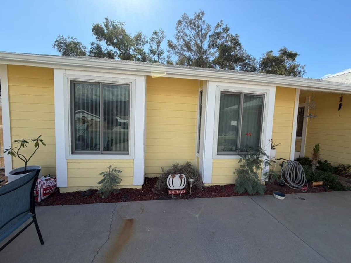 After: Patio side — new white gutters & trim